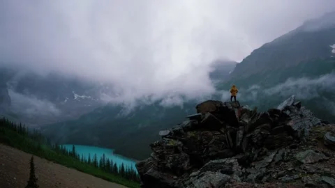 Man On Mountain Peak In Storm Video stock 230015905