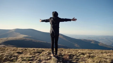 Man on mountain top looks down determined to conquer the world . Male head silho Video stock 98377611