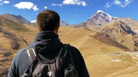 Man in Mountains against a Clear Sky on a Sunny Day Stock Footage 99595281