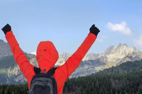 Man in mountains with hands up Stock Photos