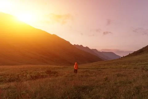 Man in the mountains at sunset Stock Photos