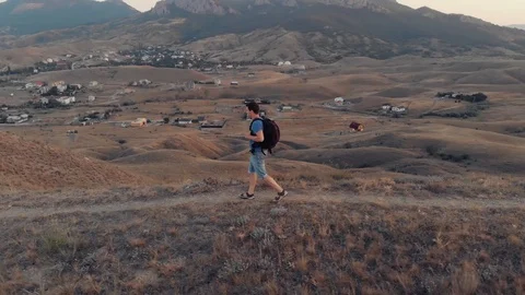 Man in mountians walking Stock Footage 93041930