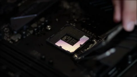 Man mounts cpu microprocessor on a computer motherboard. Hi-tech concept Stock Footage 138454981