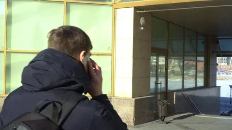 A man on the move talking on the phone Stock Footage 84284740