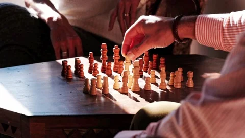 Man moves queen in a game of chess Stock Footage 339896544
