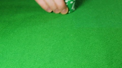 Man moves a stack of green poker chips Stock Footage 58743651