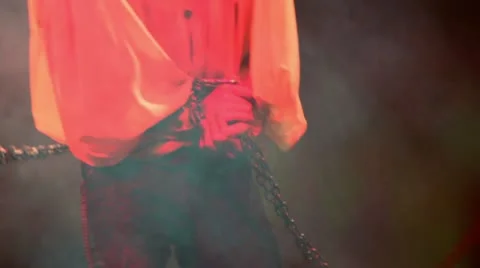 Man moves on stage with hands in chains during performance Stock Footage 22010887