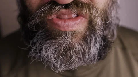 Man moves systematically moves jaw chewing something in his mouth taking teeth Stock Footage 303917595