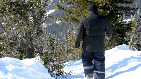 A man moves through the deep snow in winter in Sunny weather Video stock 106197385