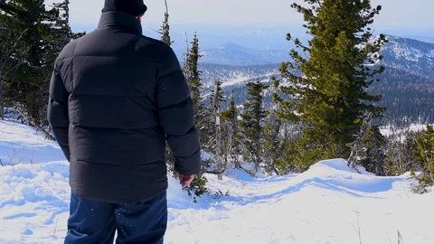 A man moves through the deep snow in winter in Sunny weather Stock Footage 107509301
