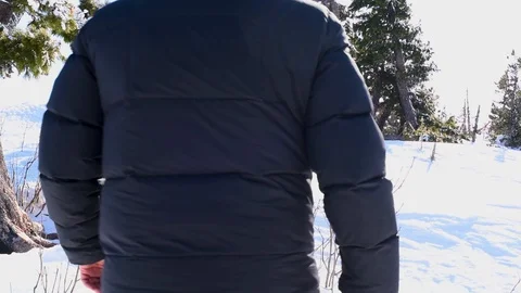 A man moves through the deep snow in winter in Sunny weather Video stock 107571253
