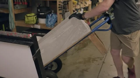 Man moving 300lbs block of ice at ice sculptors workshop Stock Footage 248937900