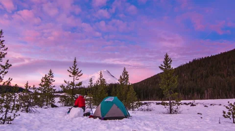 Man Moving About Snow Camp, Taking Pictures During Sunset. Stock-Footage 46230621