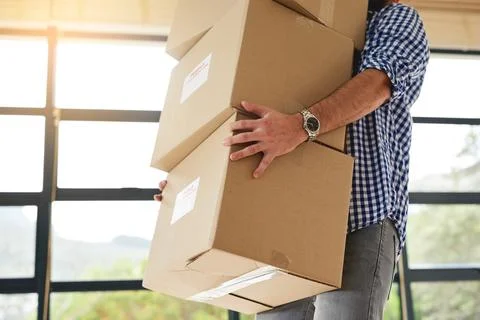 Man, moving and carry a stack of boxes in house with transport, delivery or home Stock Photos