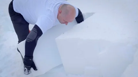 A man moving a block of ice for ice sculpting. Stock Footage 125753430