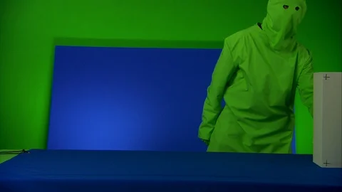 Man moving a box in front of blue/green screen, advert concept Stock-Footage 89582124