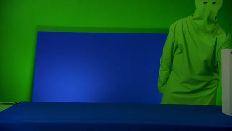 Man moving a box in front of blue/green screen, advert concept Stock Footage 89582326