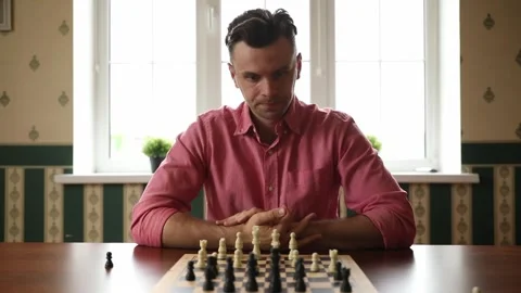 Man Moving Chess Piece on Chessboard at Home Stock Footage 332639787