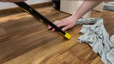 Man moving clothes drying rack across floor at home, household task, Stock Footage 337109413