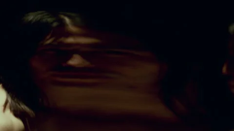Man Moving in front of Distorting Mirror Warping His Reflection in Eerie Way Stock Footage 289853729