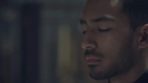 Man moving his eyes while they're closed during meditation Stock Footage 279849547