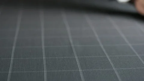 Man Moving his Hand on a Grey Checked Piece of Material Stock Footage 88879337