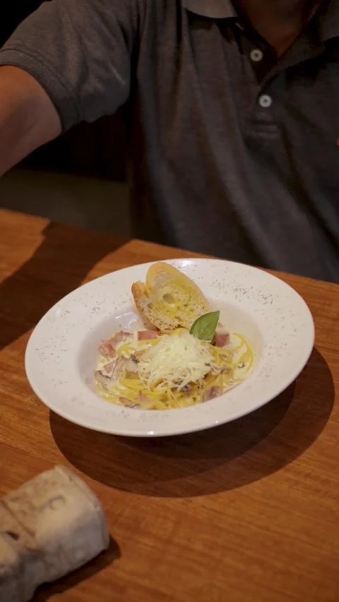 Man Moving His Hand Over A Fully Topped Spaghetti Carbonara Stock Footage 300070400