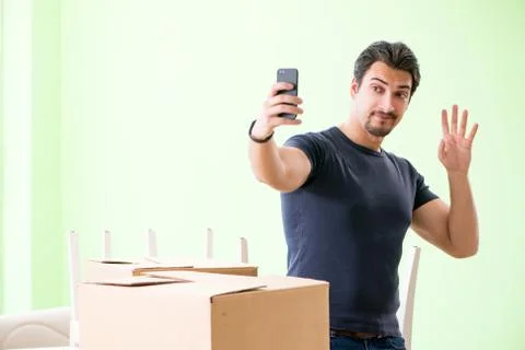 Man moving house with boxes Stock Photos