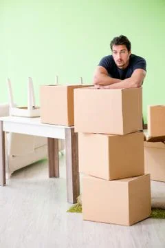 Man moving house with boxes Stock Photos