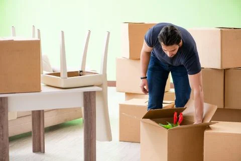 Man moving house with boxes Stock Photos