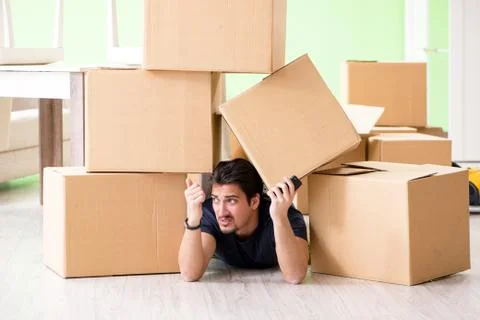 Man moving house with boxes Stock Photos