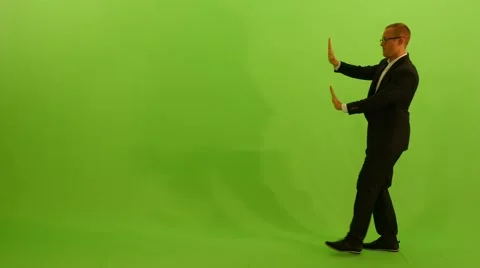 Man moving object across the room. isolated green screen background Stock Footage 64800650