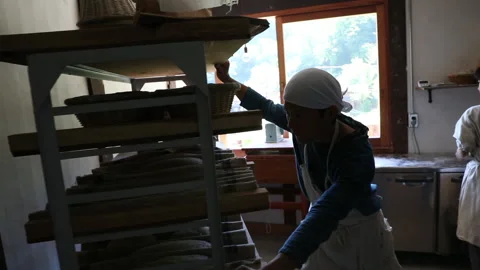 Man moving the shelf with bread Stock Footage 161888019