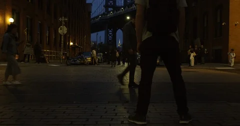 Man Moving Towards The Impressive Manhattan Bridge In Trendy Dumbo Brooklyn Stock Footage 110596621