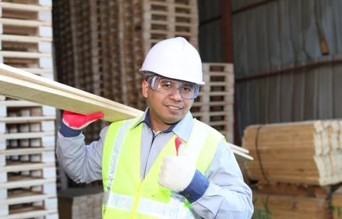Man moving wood  in a warehouse Stock Photos