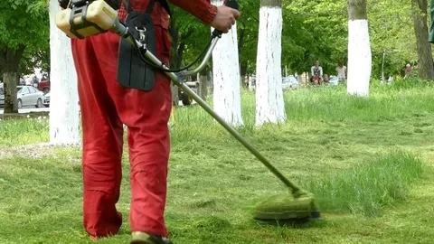 Man mowing grass Stock Footage 70000111