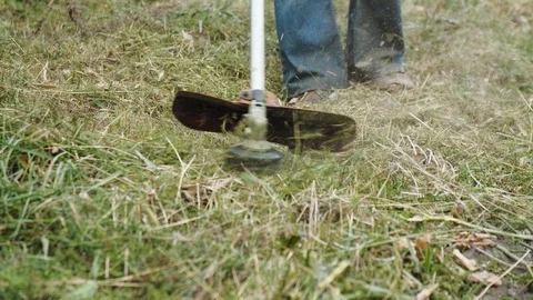 Man mowing the grass, the mower close up Stock Footage 117050385