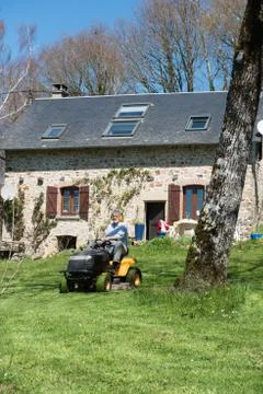 Man mowing the grass Stock Photos