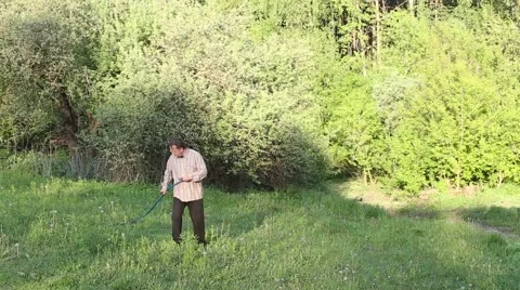 Man mowing the grass at sunset Stock Footage 62802161