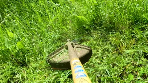 Man mowing grass with a trimmer Stock Footage 197546344