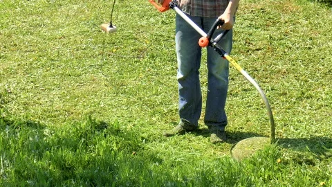 Man mows the grass Stock Footage 89958338
