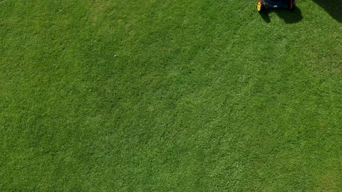 A man mows the grass in his yard. Aerial view Stock Footage 207664684