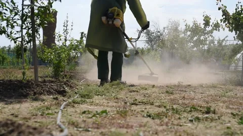 A man mows grass with a trimmer Stock Footage 131143587