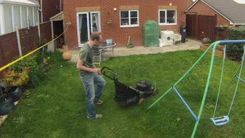 A man mows the lawn in time lapse Stock Footage 145230374