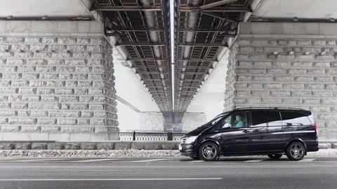 Man (MR) rides backward in black car by road Stock Footage 299678679