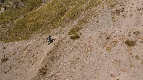 Man on mtb freerides in the high mountains Stock Footage 83712560