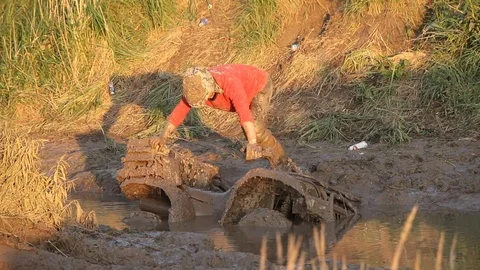 Man in the mud with a 4×4 vehicle Stock Footage 71492706