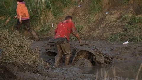 Man in the mud with a 4×4 vehicle Stock Footage 71493053