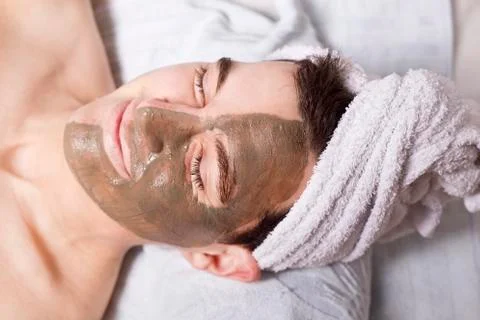 Man with a mud mask on this face Stock Photos