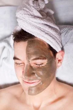 Man with a mud mask on this face Stock Photos